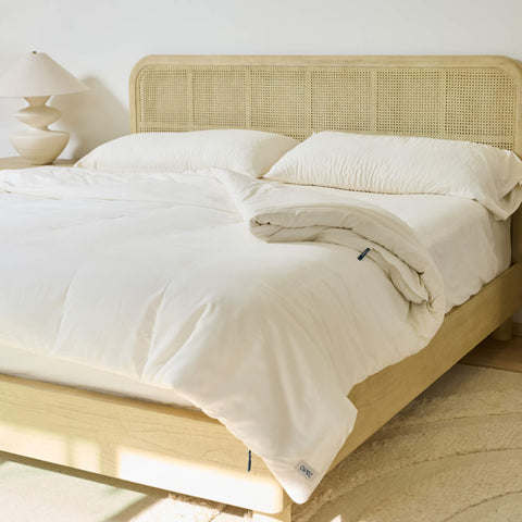 The morning sun shining on a bed with the Avec Align System linen-blend bedding