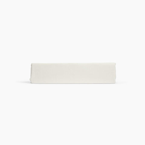 Avec linen align top sheet in bone folded neatly on a white background