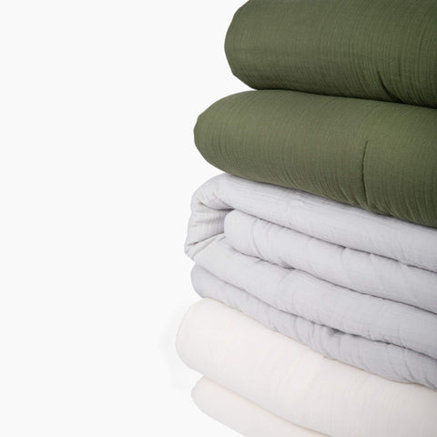 A detailed view of the fabric on the Avec lightweight cotton quilt in multiple colors
