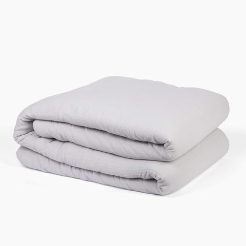 Avec lightweight cotton quilt in mist folded neatly on a white background