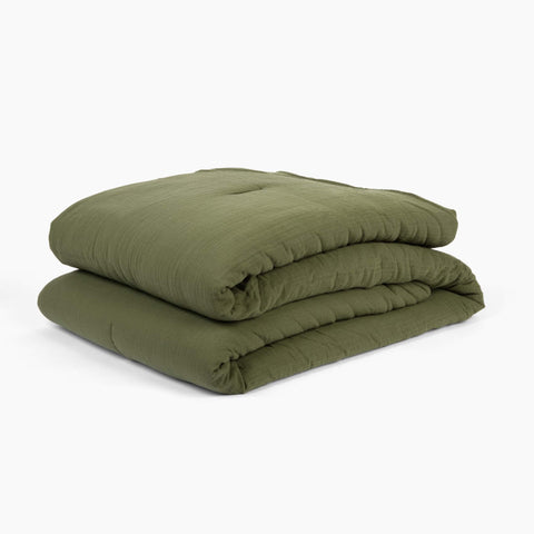 Avec lightweight cotton quilt in moss folded neatly on a white background