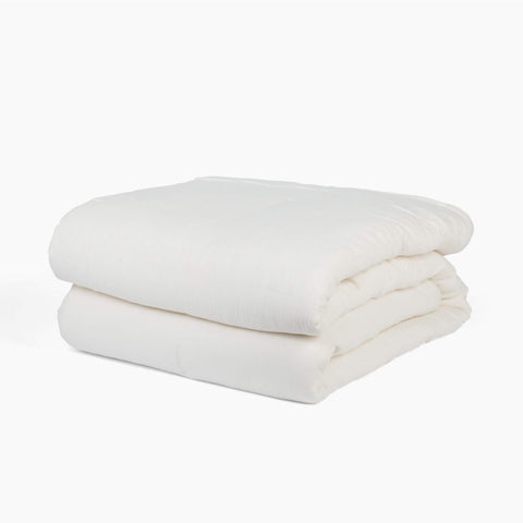 Avec lightweight cotton quilt in pearl folded neatly on a white background