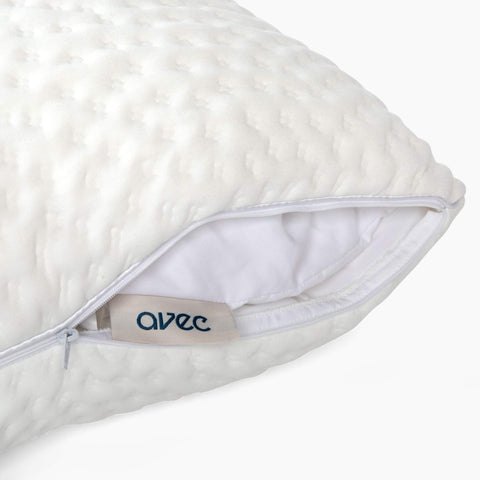 A detailed view of the zipper and insert on the Avec hybrid pillow on a white background