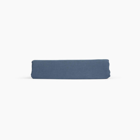 Avec linen fitted sheet in harbor folded neatly on a white background