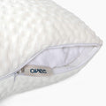 A detailed view of the zipper and insert on the Avec hybrid pillow on a white background