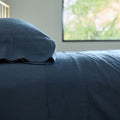 A detailed side view of a well-made bed made with Avec bedding