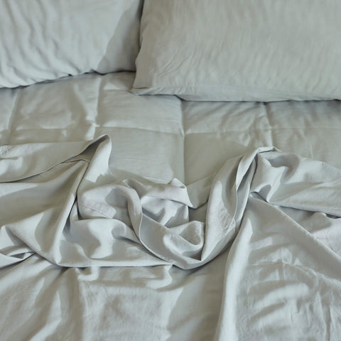 A close up view of a bed made with Avec bedding linen-blend sheets