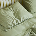 A morning view of a slept in bed made with Avec bedding